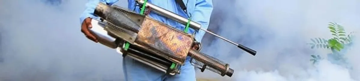 Fumigation technician using a fogger for deep pest treatment in Minneapolis, MN